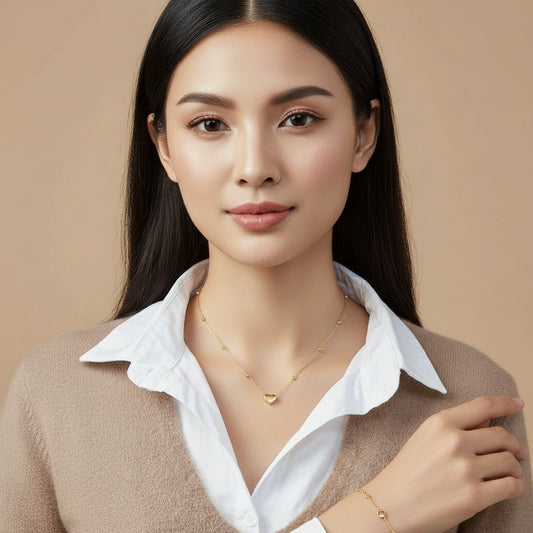 Mannequin wearing a white shirt with a gold necklace featuring a heart pendant.