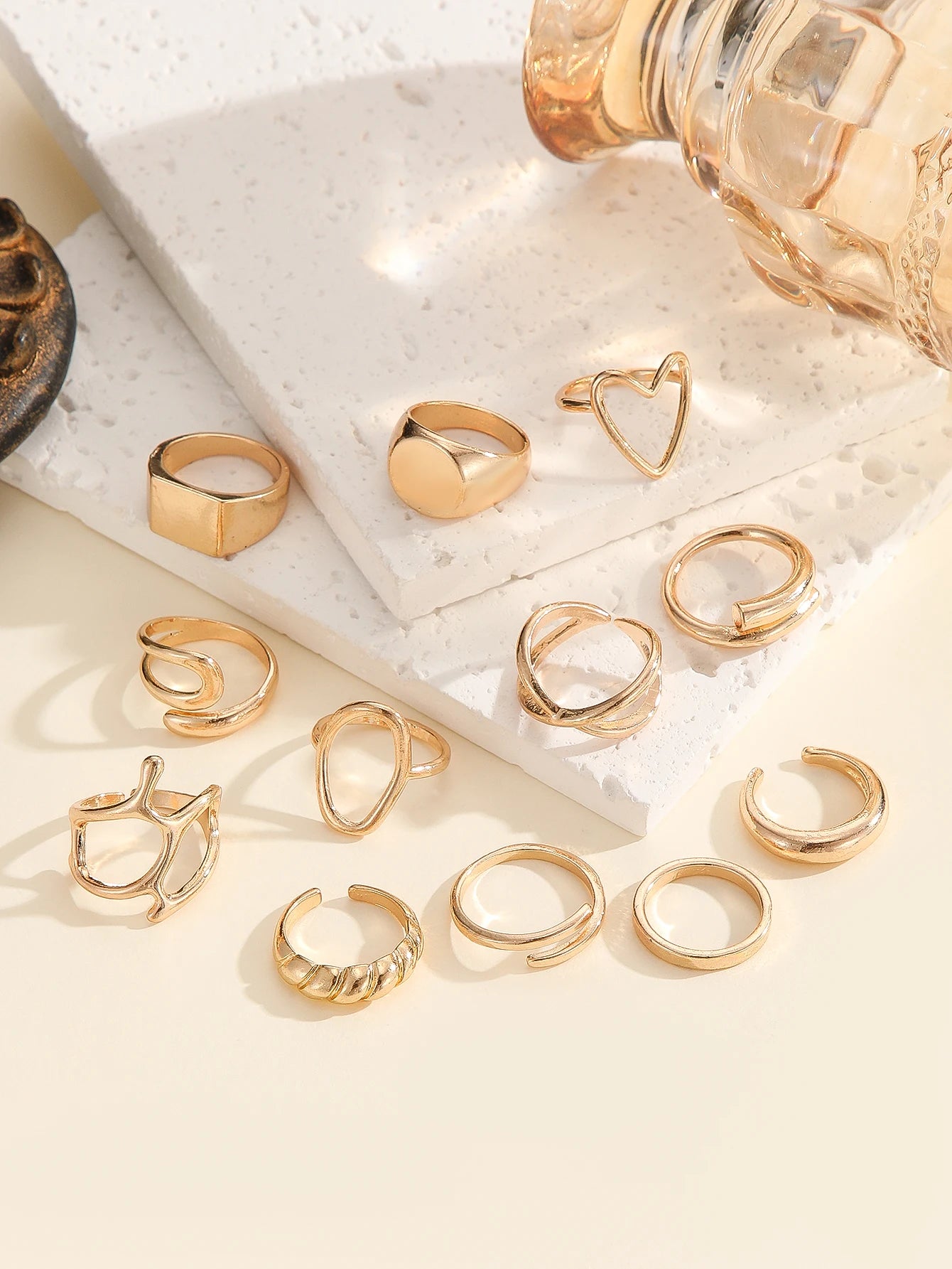 The 12-piece set of metallic-looking smooth rings is perfect for women to wear at daily parties.