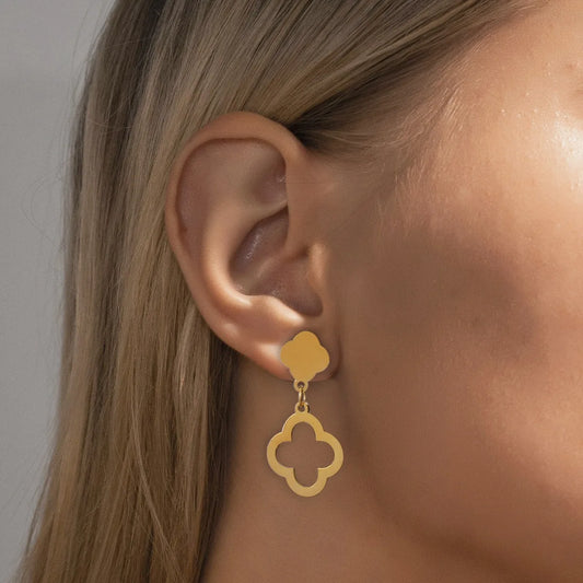 A pair of hollowed out four leaf flower earrings are exquisite, fashionable, and elegant