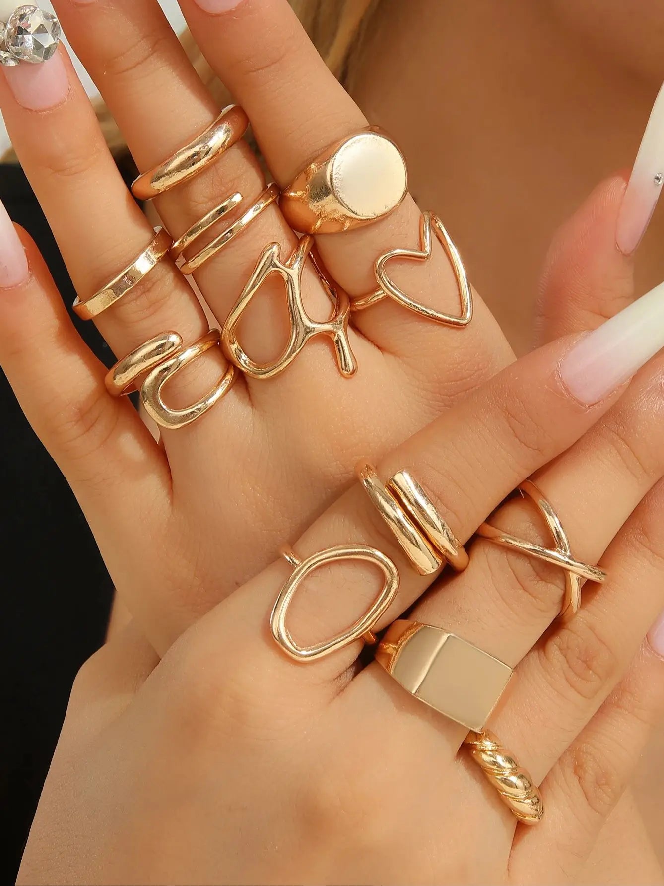 The 12-piece set of metallic-looking smooth rings is perfect for women to wear at daily parties.