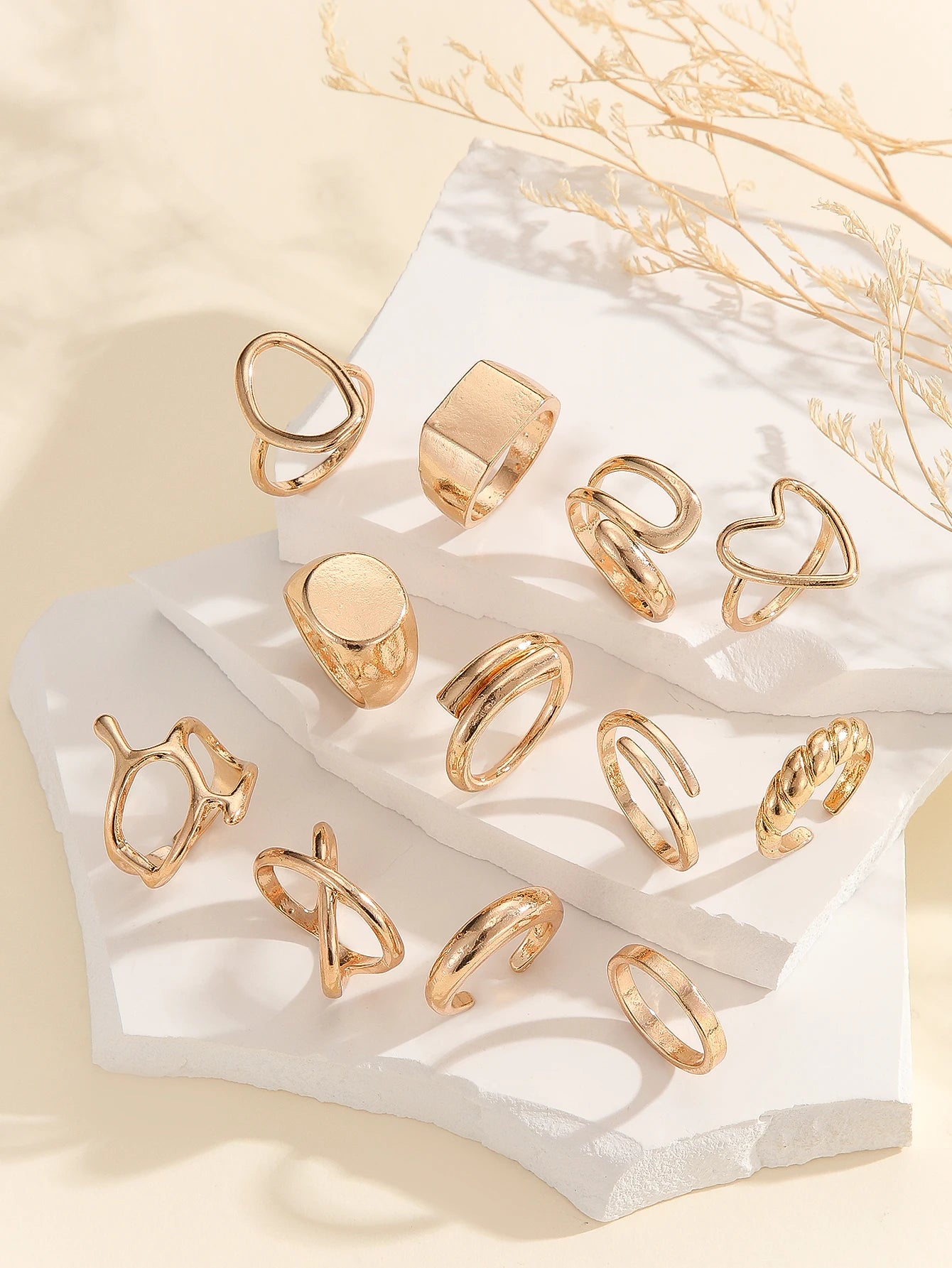 The 12-piece set of metallic-looking smooth rings is perfect for women to wear at daily parties.